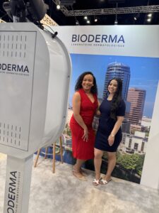 BOMBA Creative Co.'s luxury photo booth experience at Bioderma's dermatological convention in Orlando featuring professional lighting equipment and custom city skyline backdrop. Event attendees in business attire enjoying the premium photo experience that enhances brand activations at Orange County Convention Center. #LuxuryPhotoBooth #OrlandoEventPhotography #DermatologyConvention2025