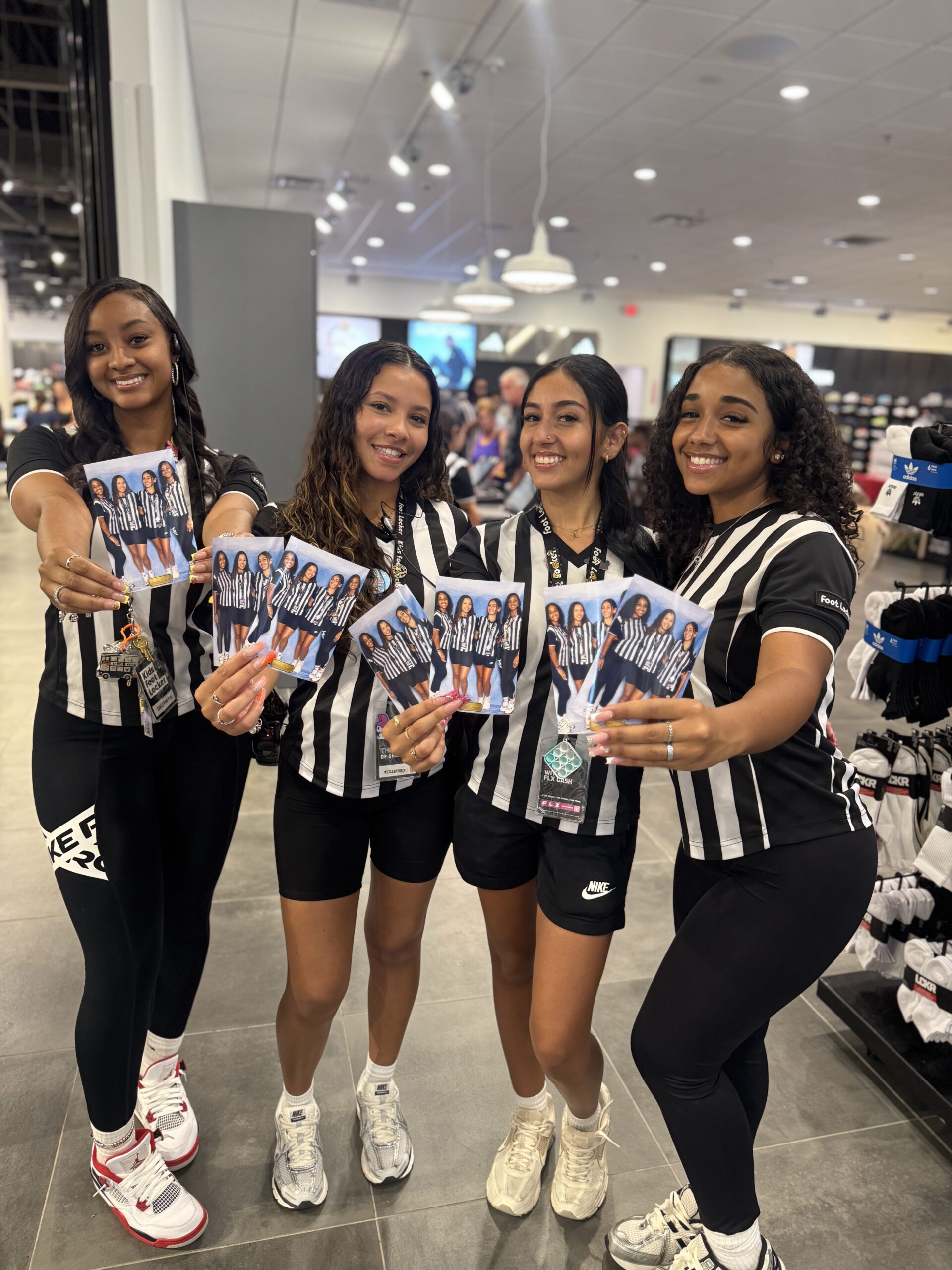 Foot Locker staff at Florida Mall Orlando proudly displaying their BOMBA Creative Co. photo prints from our luxury photo booth experience. The team in referee-style uniforms showcasing instant high-quality prints that create unforgettable moments for retail events. Our premium photo booth service with unlimited prints enhances employee engagement and creates shareable branded content for retail marketing. #OrlandoRetailEvents #FootLockerPromotion #LuxuryPhotoBooth