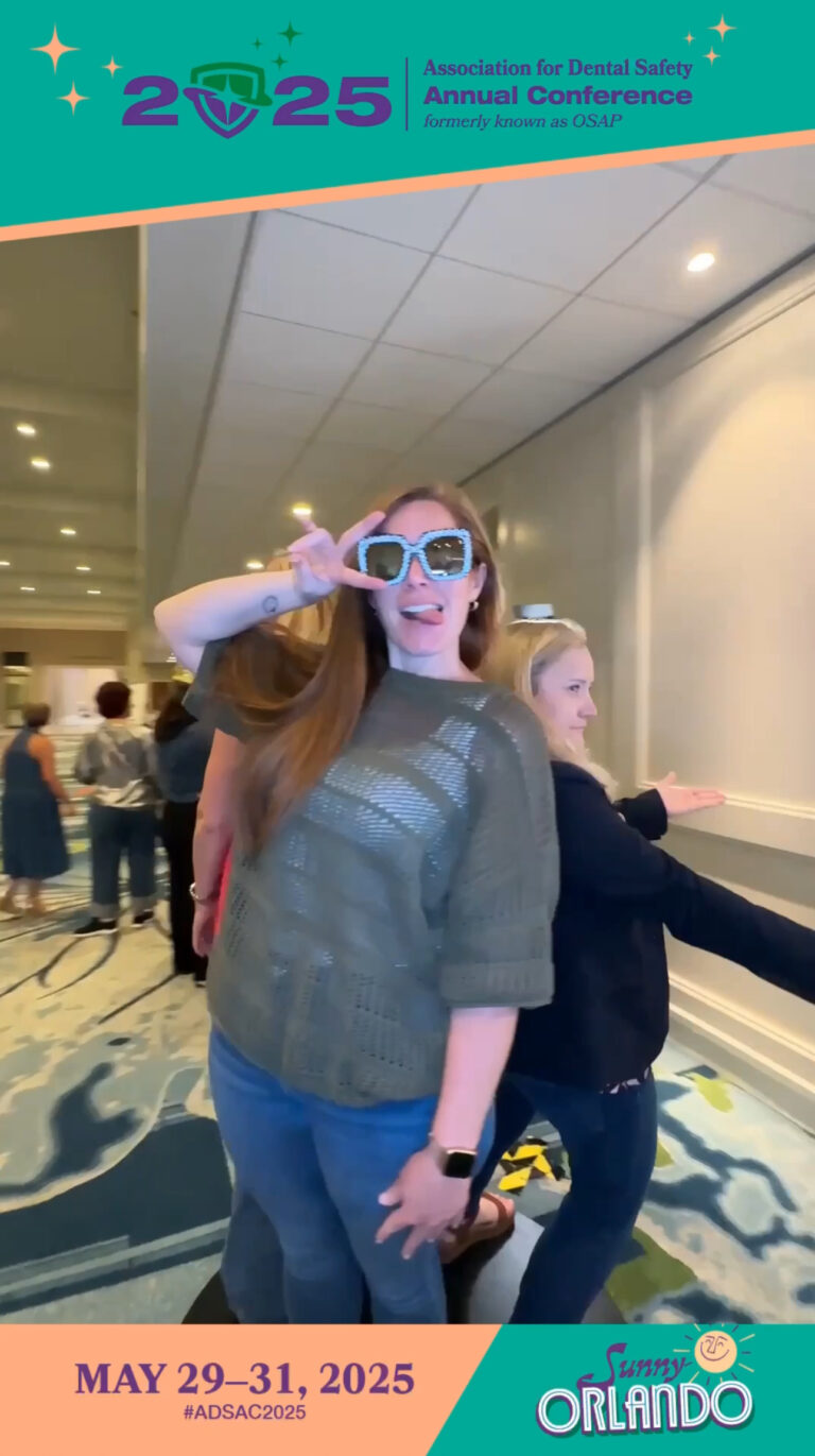 Two professional women enjoying BOMBA Creative Co 360 photo booth experience at Association for Dental Safety annual conference, Hyatt Regency Grand Cypress Resort Orlando - one wearing sparkly blue sunglasses and sequined top, both smiling and posing for luxury photo booth activation
